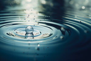 A water drop falling onto a water surface